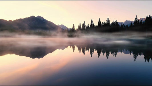 A misty alpine lake at dawn